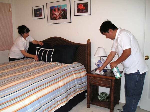 Tony and Martha making a bed during a housekeeping visit